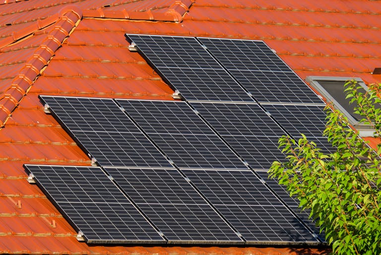 Close-up of solar panels on a red tiled roof in Croatia, highlighting renewable energy.
